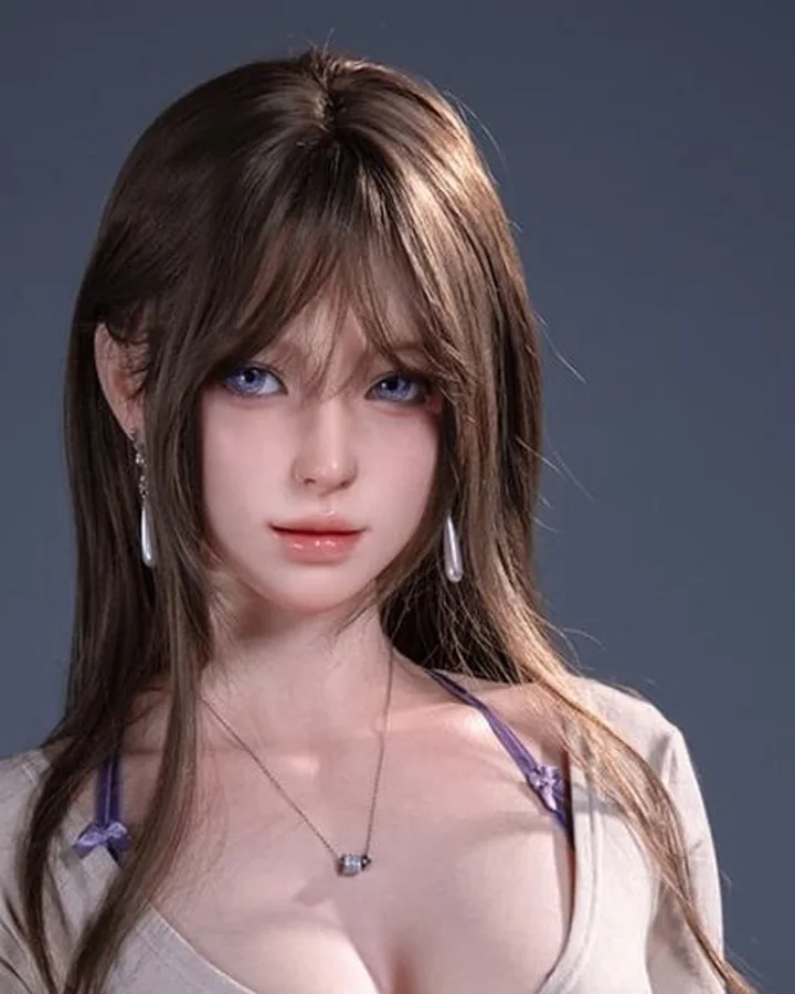 Doll with long brown hair in a beige wrap top