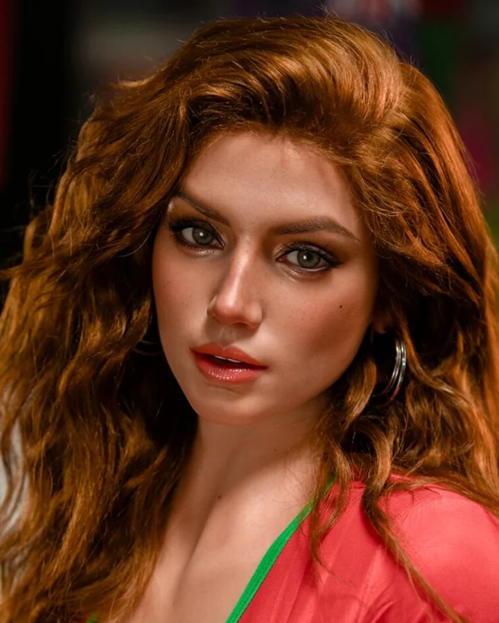 Close-up of a red-haired doll with freckles in a red top