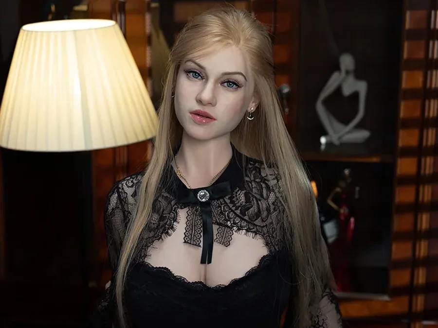 Doll with long blonde hair in a black lace dress